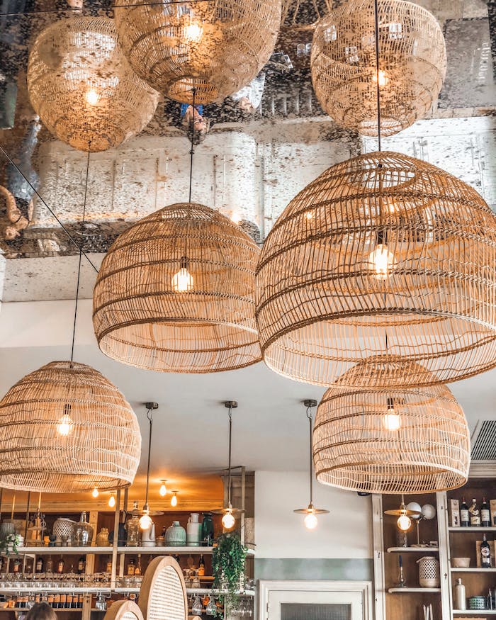 Stylish wicker pendant lights enhancing the ambiance of a modern French café in Alfortville, France.